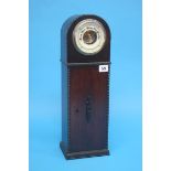 A barometer set in a 1930's oak Art Deco style clock case. 48cm height