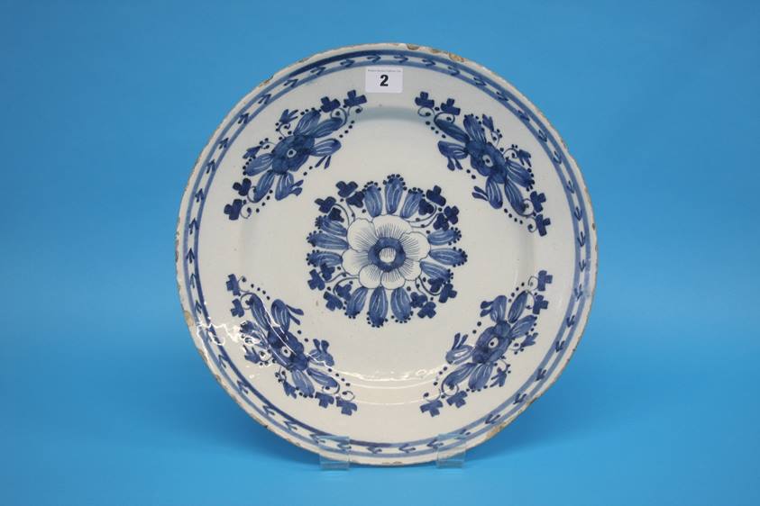 A late 18th century to early 19th century tin glazed earthenware blue and white plate. 35cm