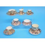 Three Derby Imari pattern cups and saucers, a Royal Crown Derby moustache cup and saucer, two
