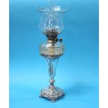 A silver plated oil lamp, with clear glass reservoir and shade
