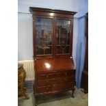 An Edwardian mahogany bureau bookcase with dentil cornice