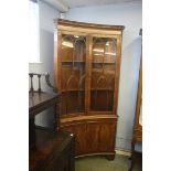 A good quality reproduction walnut concave corner cabinet