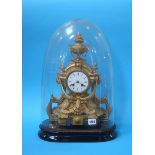 A gilt metal mantle clock, under a glass dome