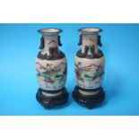 Pair of Oriental vases on carved hardwood stands