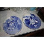 A pair of blue and white oval plaques