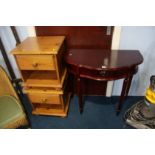 A pair of bedside cabinets and a half moon table