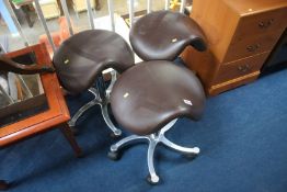 Three saddle stools