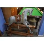 An F H Ayres rocking horse, stamped 'Harrods Knightsbridge' to stand, length of stand 40cm x