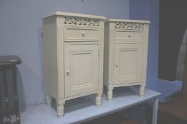 A pair of cream bedside cabinets