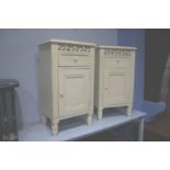 A pair of cream bedside cabinets