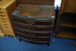 A walnut bow front chest of drawers