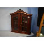 A reproduction mahogany cabinet