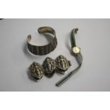 A silver bangle and gold watch etc.