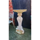 A cast iron garden bird bath