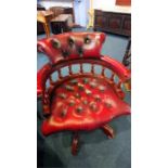 A red leather office swivel Chesterfield chair