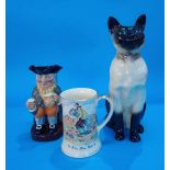 A Beswick Siamese cat, a Royal Doulton jug and a Crown Devon musical jug