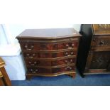 A reproduction mahogany serpentine chest of drawers