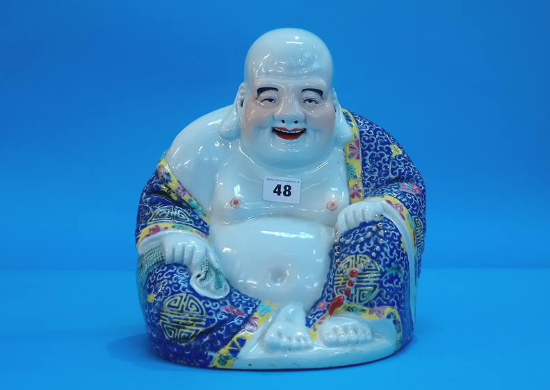 An Oriental figure, modelled as a seated Buddha