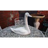 A garden statue of a swan