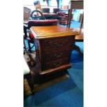 A reproduction mahogany carved three drawer chest