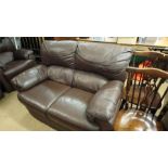 Two brown leather settees and a pair of leather armchairs