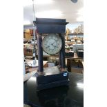 An ebonised mantle clock