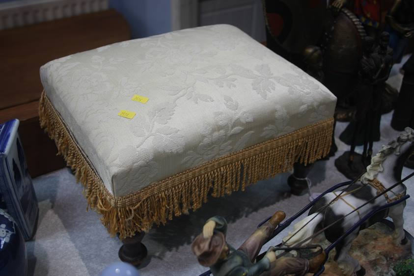 An upholstered footstool