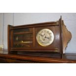 An oak cased wall clock