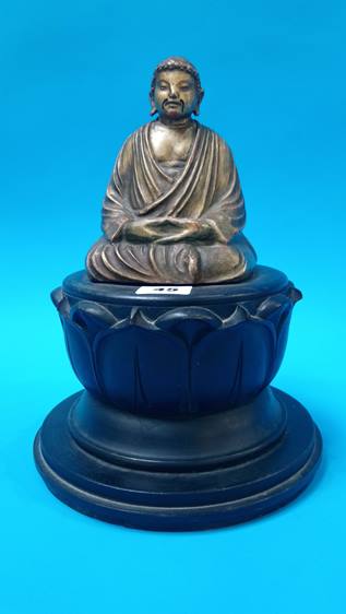 A gilt wood Buddha, resting on carved wood lotus flower 28 cm Height