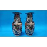 A large pair of Oriental vases, decorated with enamelled scenes