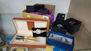 A box of modern watches and jewellery etc.