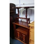 A reproduction mahogany oval table and a cabinet