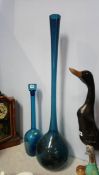 A large blue glass vase and decanter