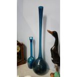 A large blue glass vase and decanter