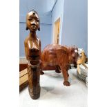 A carved hardwood figure and an elephant