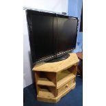 A Bush TV and a pine TV stand