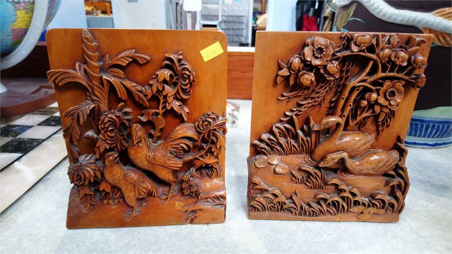 A pair of heavily carved Oriental bookends