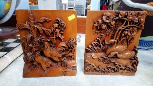 A pair of heavily carved Oriental bookends