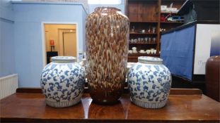A pair of ginger jars and a large vase