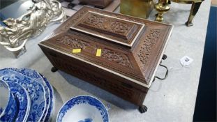 A carved wooden jewellery casket