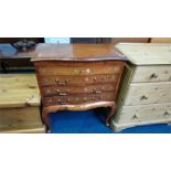 An Oriental serpentine chest of drawers