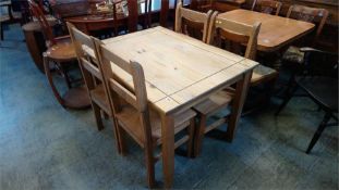 A pine table and four chairs