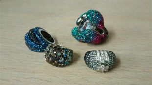 A boxed Swarovski ring and three others (4)