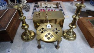 A brass tobacco box, a trivet and a pair of candle sticks