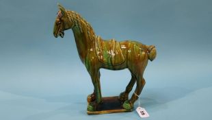 An Oriental figure of a horse decorated in green glaze (a/f)