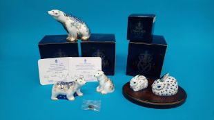 Three Royal Crown Derby paperweights; 25th anniversary rabbit and baby rabbit, with stand, 25th