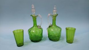 A pair of green glass jugs, with stoppers and two glasses