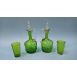 A pair of green glass jugs, with stoppers and two glasses