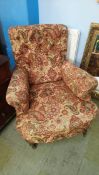 An upholstered Edwardian easy chair