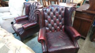 A pair of Oxblood Chesterfield high back armchairs
